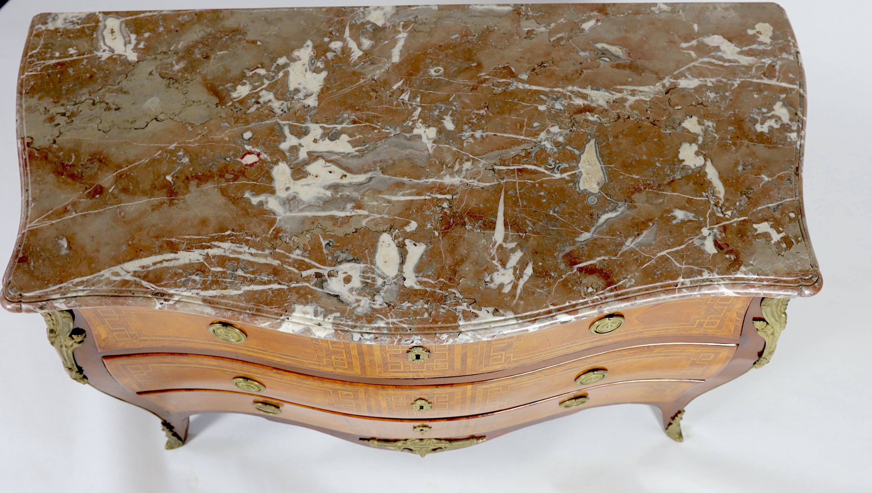 A late 18th century French banded kingwood serpentine marble top commode, with gilt metal mounts, stamped H. Wirtz to top, width 148cm, depth 69cm, height 90cm
